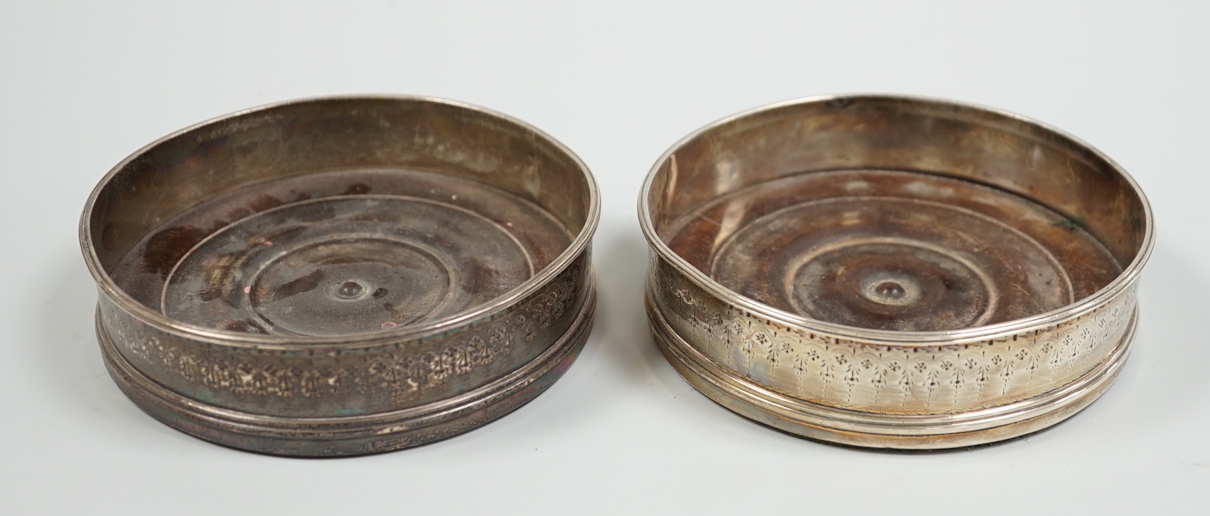 A pair of George III silver mounted wine coasters, makers mark rubbed, London, 1786, diameter 11.4cm.